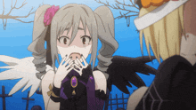 a girl with wings and a flower in her hair is covering her mouth with her hands