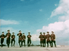 a group of men in military uniforms are standing in a row