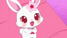 a white rabbit with a pink flower in its hair