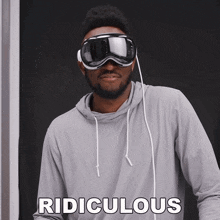 a man wearing a hoodie and goggles with the word ridiculous written on the bottom