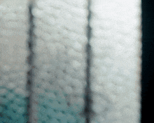 a blurred image of a knitted fabric with a blue background
