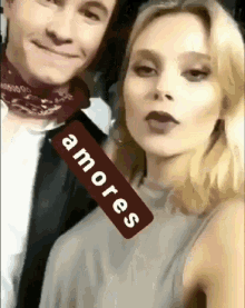 a man and a woman are standing next to each other with a sign that says amore on it