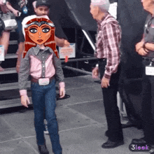 a man in a plaid shirt is standing next to a girl in a cowboy outfit