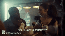 a man and a woman are sitting at a table in a restaurant and the man is asking the woman if she has a choice .