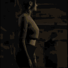 a woman in a green crop top and black pants