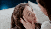 a woman is touching another woman 's face with her finger