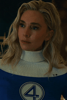 a woman with blonde hair is wearing a blue and white costume with the number 4 on it