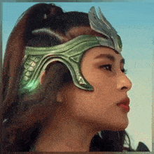 a woman wearing a green helmet and a ponytail