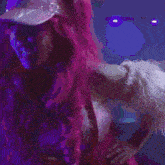 a woman with pink hair is wearing a white hat