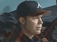 a man wearing a hat with a letter a on it