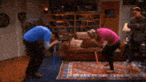 a man and a woman kneeling down in front of a couch