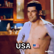 a shirtless man says usa with an american flag