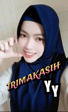 a woman wearing a blue hijab with the words trimakasih yy written on the bottom