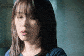 a close up of a woman 's face with a serious look on her face