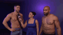 a man without a shirt is being interviewed by a woman with a microphone that says nww on it