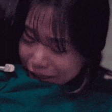 a close up of a woman 's face with tears coming out of her eyes