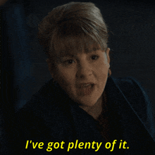 a woman says " i 've got plenty of it " in a dark room
