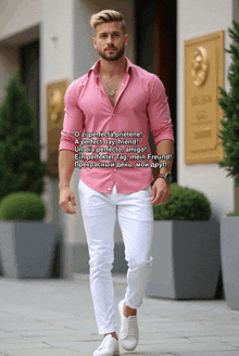 a man in a pink shirt and white pants is walking down a sidewalk