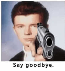 a man is pointing a gun at the camera and saying `` say goodbye . ''