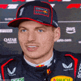 a man wearing a blue hat that says oracle red bull racing