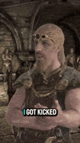 a man with a beard and a crown says " i got kicked "