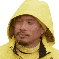 a man wearing a yellow jacket with a hood on