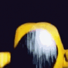 a yellow object is against a dark background