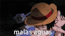 a man in a straw hat is hugging another man with the words " malas aguas " below him