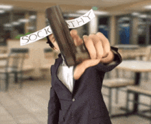 a man in a suit is holding a gun with a piece of paper that says society on it