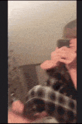 a blurry picture of a person taking a picture with a cell phone