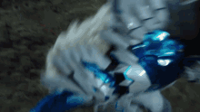 a blurred image of a blue and white object with a dark background