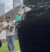 a blurry photo of a man holding a sign that says ' i love you ' on it