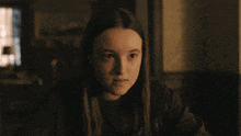 a close up of a girl 's face with a dark background