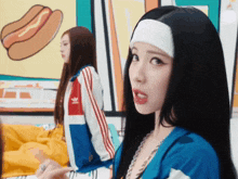 a woman wearing a headband and a blue adidas jacket