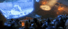 a crowd of people are gathered in front of a screen that says 00