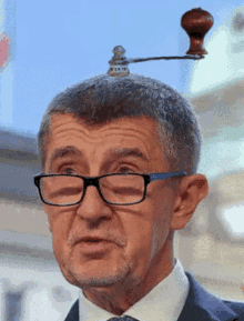 a man wearing glasses and a coffee grinder on his head