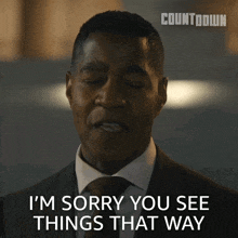a man in a suit and tie has his eyes closed and says i 'm sorry you see things that way