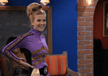 a woman in a purple outfit is smiling in front of a blackboard that says off today