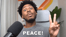 a man giving a peace sign in front of a microphone with the word peace below him