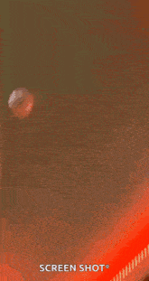 a person is standing in front of a red light and taking a screenshot .