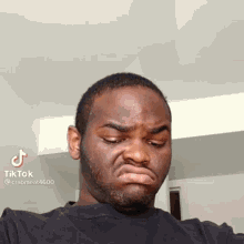 a man with a beard is making a funny face with a tiktok watermark on the bottom