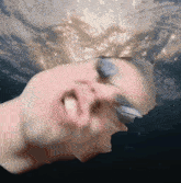 a close up of a person 's face with water coming out of their eyes