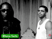 two men standing next to each other with a green button that says tune facts on it
