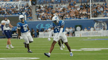 a football player with the number 17 on his helmet stands on the field