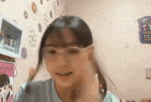a young girl wearing glasses is making a funny face .