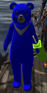 a blue teddy bear is holding a green block