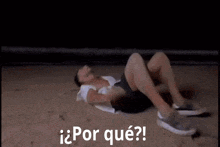 a man is laying on his back on the ground with the words por que written above him