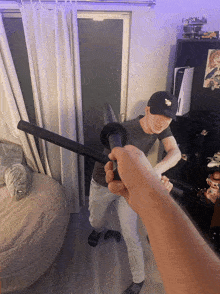 a man in a black hat holds a black sword