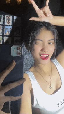 a woman is taking a picture of herself in a mirror with her phone