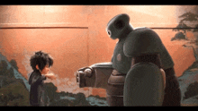 a boy and a robot are standing next to each other in front of a wall .